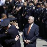 New York City Police Commissioner Bill Bratton waited with police officers outside of Jamaica Hospital in New York on Monday.