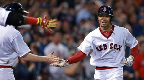 05/05/15: Boston, MA: The Red Sox Mookie Betts gets the hero's welcome as he heads for the dugout following his second solo home run of the game, which came in the bottom of the 8th inning. The Boston Red Sox hosted the Tampa Bay Rays in a regular season MLB game at Fenway Park. (Globe Staff Photo/Jim Davis) section: sports topic: Red Sox-Rays(1)
