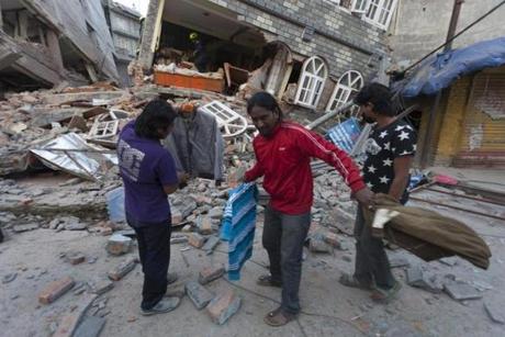 Locals searched near at collapsed house after another powerful earthquake struck in Kathmandu.
