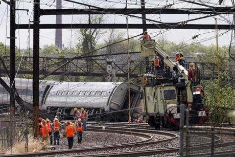 Officials worked at the site of the derailed Amtrak train in Philadelphia.
