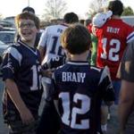 Fans wearing Tom Brady jerseys wait in line to hear the Patriots quarterback speak at a recent Salem State University event.