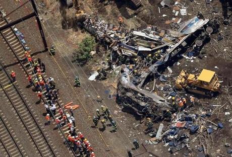 Investigators and first responders worked near the wreckage of an Amtrak passenger train that was carrying more than 200 passengers. 
