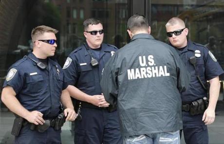 A US Marshal instructed Homeland Security officers outside the Moakley Federal Courthouse.
