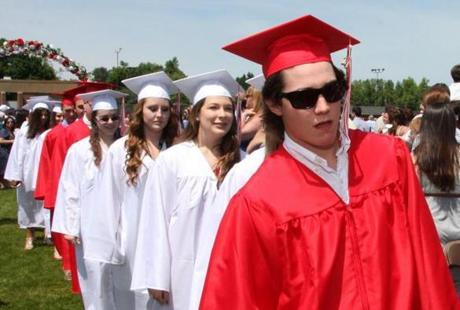 Young men and women wore different-colored gowns at East Longmeadow High School?s 2014 commencement.
