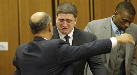 Michael Brelo hugs his attorney, Patrick D?Angelo, after the verdict in his trial Saturday, May 23, 2015, in Cleveland. Brelo, a patrolman charged in the shooting deaths of two unarmed suspects during a 137-shot barrage of gunfire was acquitted Saturday in a case that helped prompt the U.S. Department of Justice determine the city police department had a history of using excessive force and violating civil rights. (AP Photo/Tony Dejak)
