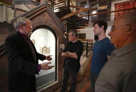At the Armenian Library and Museum of America in Watertown, curator Gary Lind-Sinanian (left) and director Berj Chekijian (right) give Eric Bogosian and his son Travis (center) a tour.
