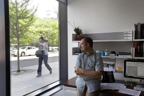 Dr. Emanuele Mazzola, a biostatistician with the Dana Farber Cancer Institute in his office at 360 Longwood Avenue, which looks out on a busy sidewalk. 
