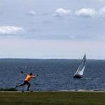A skate boarder on the walking path at Fort Taber Park in New Bedford.. 