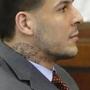 Former New England Patriots NFL football player Aaron Hernandez listens during his arraignment on a charge of trying to silence a witness in a double murder case against him by shooting the man in the face at Suffolk Superior Court Thursday, May 21, 2015, in Boston. (AP Photo/Stephan Savoia, Pool)