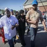 Ibrahim and Rahimah Rahim (center) left after attending a news conference at the site in Roslindale where Usaama Rahim was shot on Tuesday.