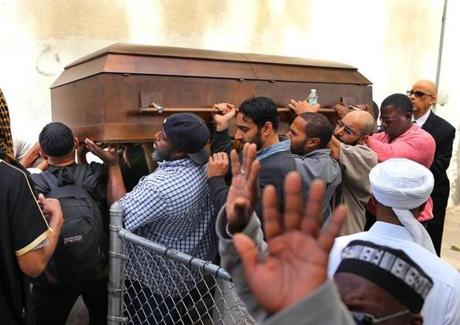 A funeral service was held for  Usaama Rahim at a mosque on Shawmut Avenue. His casket was carried to the hearse. 
