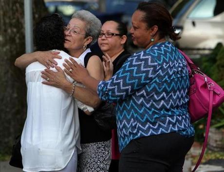 Boston, MA - 06/10/15 Chantey Pagan, 32, in white back to camera, is comforted outside the Brady Fallon Funeral Home where friends and family mourned Yadielys Deleon Camacho who was killed by a hit and run driver. Pagan is the mother of Joseph Eduardo Cordova, 12, who was also struck by the same hit and run driver and who remains hospitalized. - (Barry Chin/Globe Staff), Section: Metro, Reporter: Travis Andersen, Topic: 11funeral, LOID: 8.1.1326762908. 
