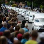 Students from the Joseph-Koenig-Gymnasium high school watched as hearses carrying the remains of 16 of their fellow students and two teachers who were killed in the Germanwings plane crash drove by Wedesday. 
