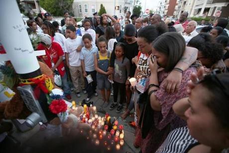 Family and friends of Jonathan Dos Santos, who was shot and killed while riding his bicycle, gathered for a vigil in Dorchester.

