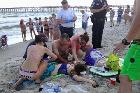 Emergency responders assisted a teenage girl at the scene of a shark attack in Oak Island, N.C., on Sunday. 
