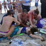 Emergency responders assisted a teenage girl at the scene of a shark attack in Oak Island, N.C., on Sunday. 