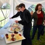 Olive Chase (right) talked to catering servers Kate Ryan (left) and Kitty Archer as they set up for an event in Osterville.
