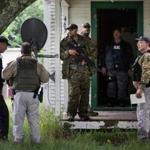 A task force of US Marshalls and police officers went door-to-door searching for two escaped convicts Tuesday. 