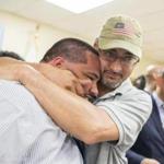 Graduate Donan Cosme, left, is hugged by his godfather Raymond Vega after the Operation Exit Pre-Apprenticeship Program graduation on Wednesday.