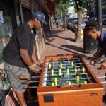 Cedric Douglas (left) plays foosball with a friend in Dorchester. 