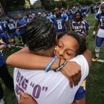 Odin Lloyd's mother, Ursula Ward (right), and girlfriend, Shaneah Jenkins, shared an embrace during a pre-game ceremony honoring Lloyd.