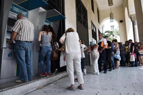 People lined up at ATMs outside a national bank branch in the northern Greek port city of Thessaloniki on Monday.
