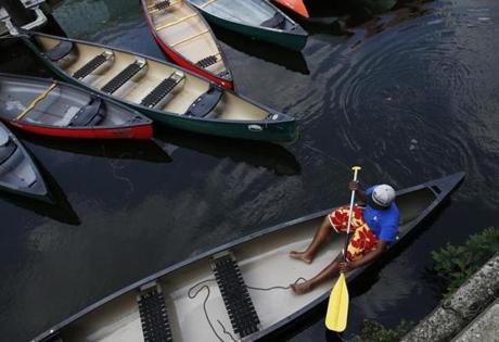 Imani Holland, a 17-year-old dockhand with Charles River Canoe & Kayak, helped prepare a canoe on Wednesday for an influx of customers expected during the Fourth of July holiday weekend in Cambridge.
