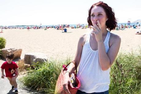 Sarah Norris, in a Craigville Beach parking lot, said she thought smoking was ?frowned upon,? rather than prohibited. 
