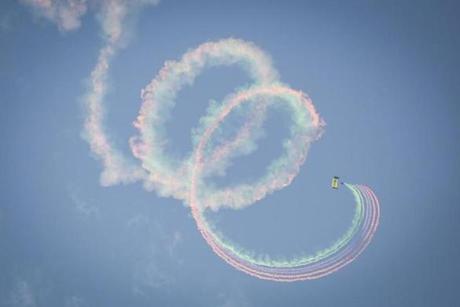 Members of the Navy's Leap Frogs created streams of colored smoke as they jumped from a plane for an aerial show.
