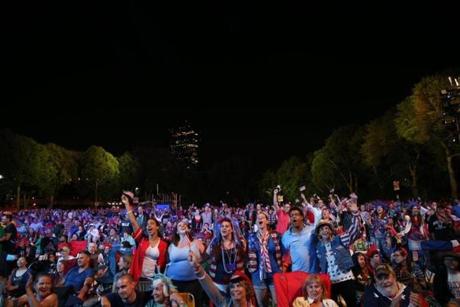 People sang along with the Boston Pops performance on the Charles River Esplanade during Fourth of July celebrations.  
