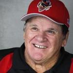 Pete Rose visits with members of the Washington Wild Things in their dugout before a Frontier League baseball game against the Lake Erie Crushers in Washington, Pa, Tuesday, June 30, 2015. Rose coach each baseline for a half inning for the Wild Things after which fans could pay for an autograph and to have their picture take with him. (AP Photo/Gene J. Puskar) 