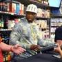 Rapper 50 Cent autographs bottles of Effen Vodka for a promotional event at Billy?s Liquors in Abington last month. 