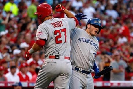 CINCINNATI, OH - JULY 14: American League All-Star Mike Trout #27 of the Los Angeles Angels of Anaheim celebrates with teammate American League All-Star Josh Donaldson #20 of the Toronto Blue Jays after scoring a lead off home run in the first inning against National League All-Star Zack Greinke #21 of the Los Angeles Dodgers during the 86th MLB All-Star Game at the Great American Ball Park on July 14, 2015 in Cincinnati, Ohio. (Photo by Rob Carr/Getty Images)
