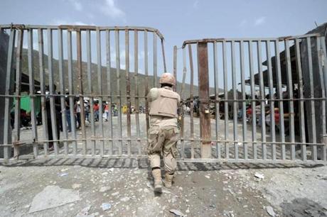 A Dominican soldier watched the border crossing at Malpasse, Haiti, in June. 
