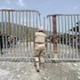 A Dominican soldier watched the border crossing at Malpasse, Haiti, in June. 