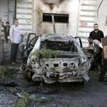 Palestinians gathered around a burnt-out car in Gaza City on Sunday after explosions destroyed five cars belonging to members of Hamas and Islamic Jihad, witnesses and a security source said.