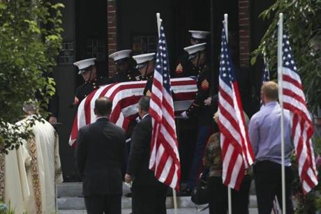 Springfield, MA - 7/27/2015: United States Marines carry a casket with the body of Thomas Sullivan out of Holy Cross Catholic Church during his funeral ceremony in Springfield, MA on July 27, 2015. (Harrison Hill for The Boston Globe)
