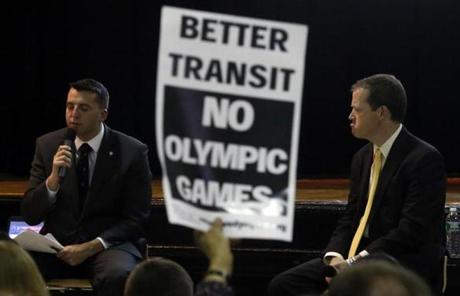 A Boston Olympics opponent held a sign at a public forum earlier this year.
