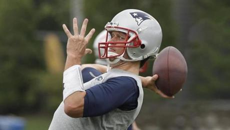 New England Patriots quarterback Tom Brady (12) throws a pass during an NFL football minicamp Tuesday, June 16, 2015, in Foxborough, Mass. (AP Photo/Stephan Savoia)
