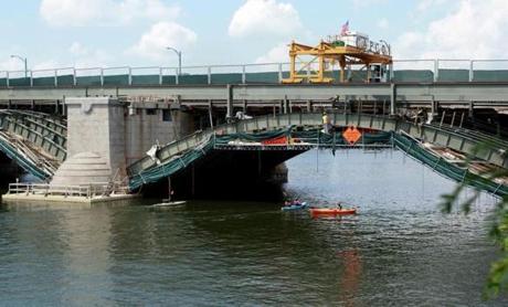 Kayakers passed under the Longfellow Bridge as it undergoes a restoration project.
