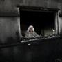 A Palestinian man looks out from a house that was badly damaged from a suspected attack by Jewish extremists near the West Bank city of Nablus on Friday.
