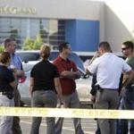 Investigators stood outside a movie theatre where a man shot and killed filmgoers in Lafayette, La.