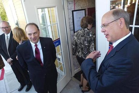 Primary Bank founder Bill Greiner (left) and chief executive Bill Stone greeted guests as the Bedford, N.H., bank opened on Friday.
