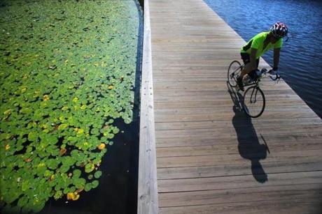 A cyclist crossed a bridge in Christian A. Herter Park on the Charles River.

