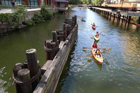 A colorful line of kayakers headed down Broad Canal in Cambridge from the Kendall Square home of Charles River Canoe & Kayak on Sunday, taking advantage of a sunny summer day to get a surface view of the Charles River.
