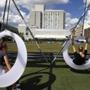 Sisters Mia, 15, (left) and Tal Ginsburg, 21, of Los Angeles were on the swings at the Lawn on D in South Boston on Wednesday. 