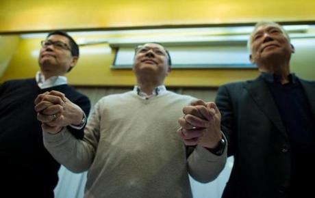 Prodemocracy activists and cofounders of the Occupy movement in Hong Kong (from left) Kin-man Chan, Benny Tai, and the Rev. Yiu-ming Chu, showed their unity after announcing on Dec. 2, 2014, that they would turn themselves into police. Tai, an associate law professor at the University of Hong Kong, has had professional problems since the protest that shut down parts of the city and angered China?s government.
