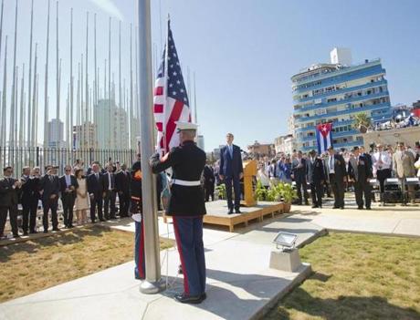 Secretary of State John Kerry (center) stood with other dignitaries as members of the Marines raised the US flag over the newly reopened embassy in Havana, Cuba, on Friday.
