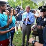 Boston police, including Commissioner William Evans, handed out ice cream near the location where shots were fired Monday.