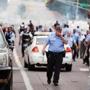 Police fired what appeared to be tear gas in an effort to disperse a crowd after officers shot and killed a young black man.